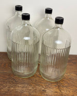 Image of four large BDO ribbed Apothecary bottles