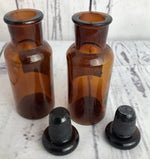 Pair of vintage amber stoppered bottles