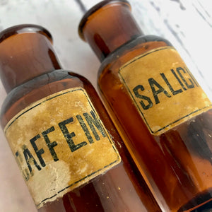Pair of vintage amber stoppered bottles