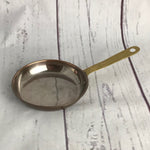 7 graduated lined copper pans with brass handles